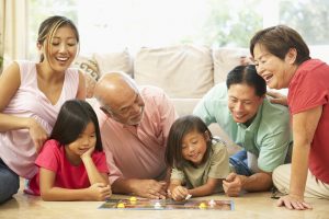 Family playing board game together at home.