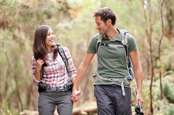 Couple hiking together in a forest.