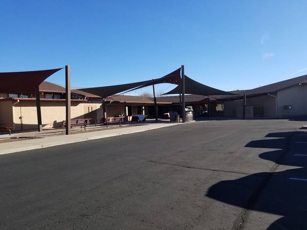 Outdoor courtyard with shade structures and benches.